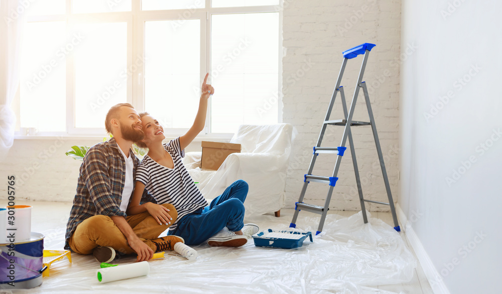 young happy family married couple dreams of renovating  house and planning  design project.