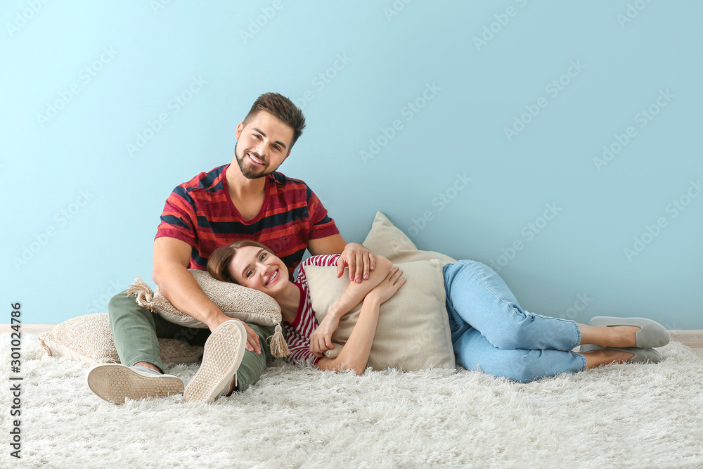 Portrait of happy young couple resting indoors