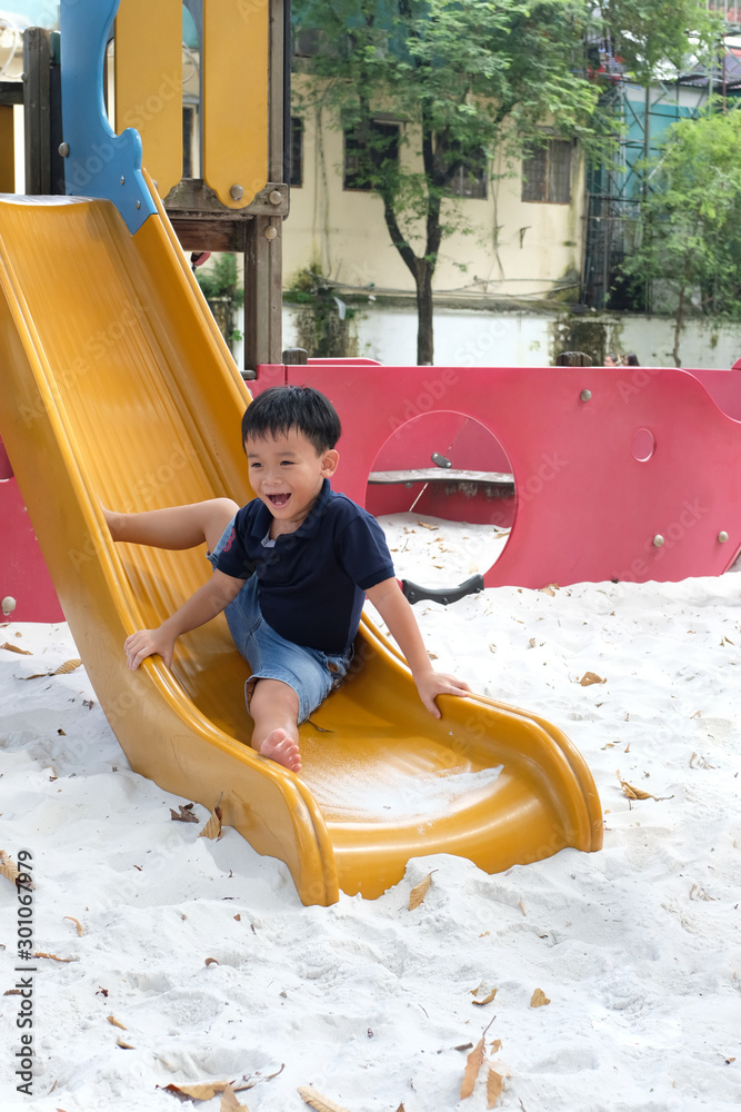 Child playing on outdoor playground. Kids play on school or kindergarten yard.