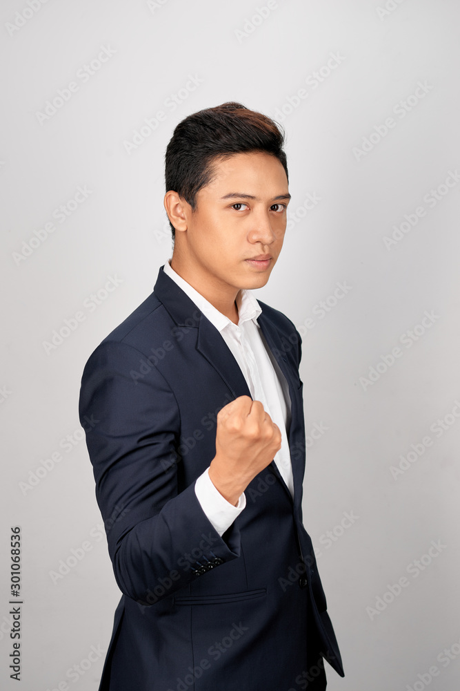 Young businessman showing a fist bump over white background