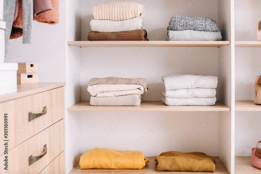 Wardrobe with stacks of clean clothes