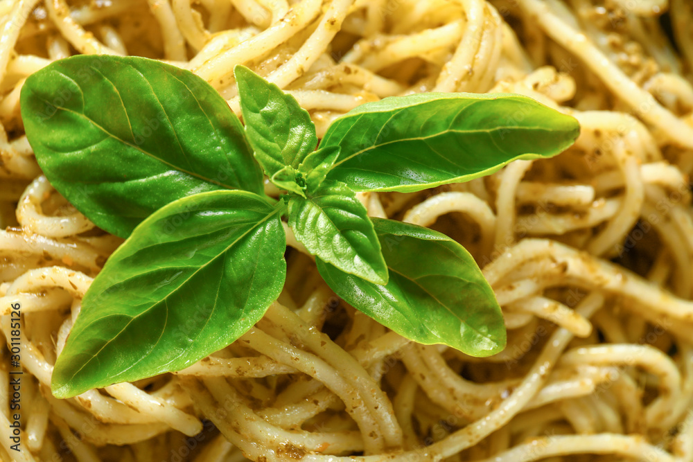 Tasty pasta with pesto sauce, closeup