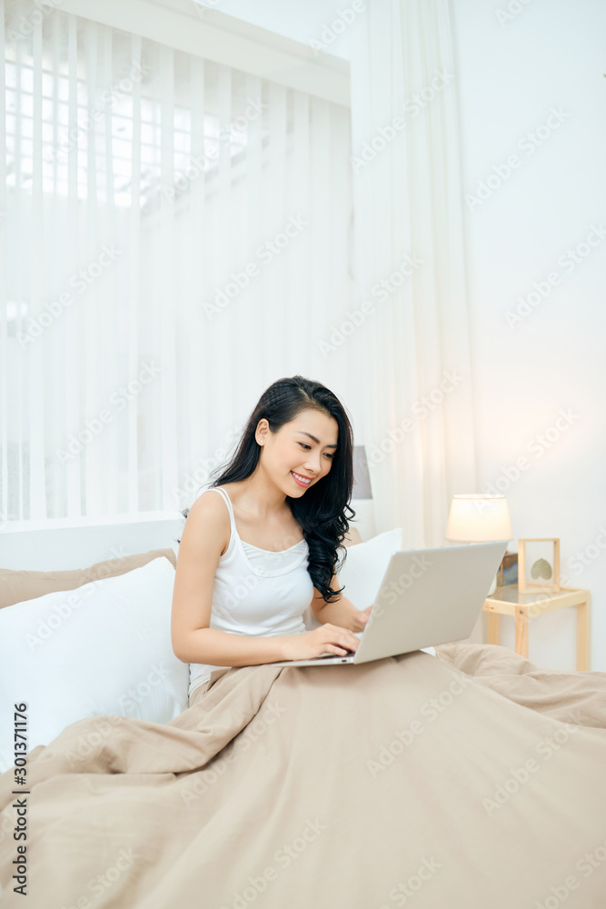 Young Lady smile and happy while write massage in email.