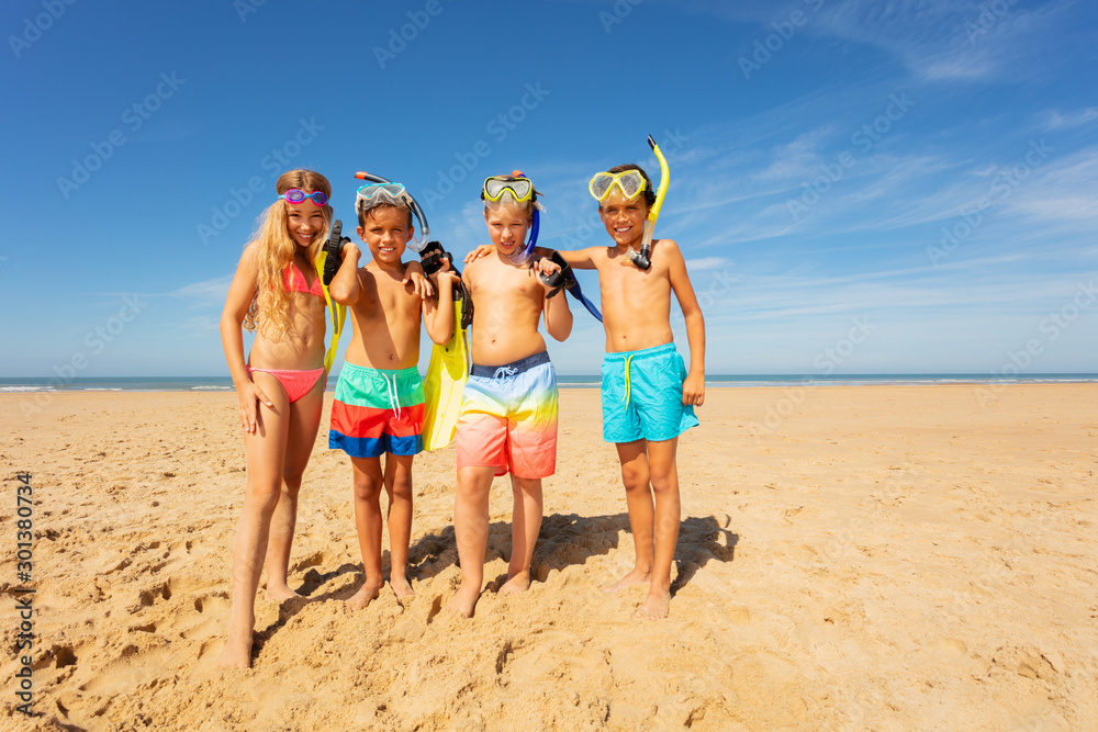 Friends group on the beach with snorkeling tools