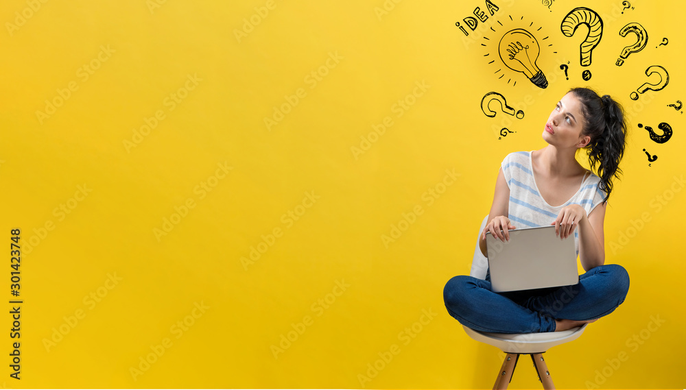 Idea light bulbs with question marks with young woman using a laptop computer