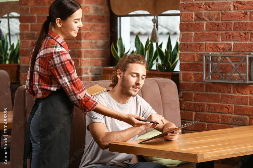 Waitress serving client in restaurant