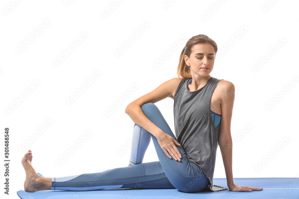 Beautiful young woman practicing yoga on white background