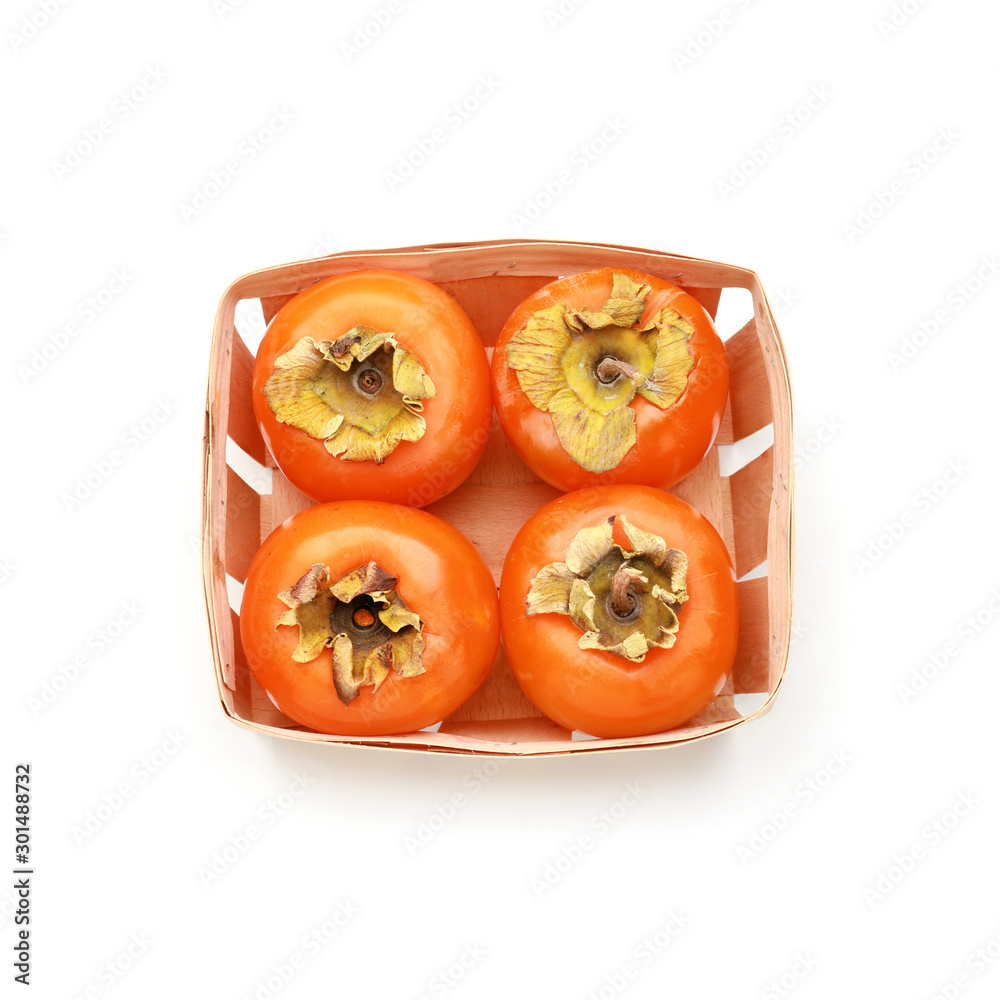 Box with ripe persimmons isolated on white