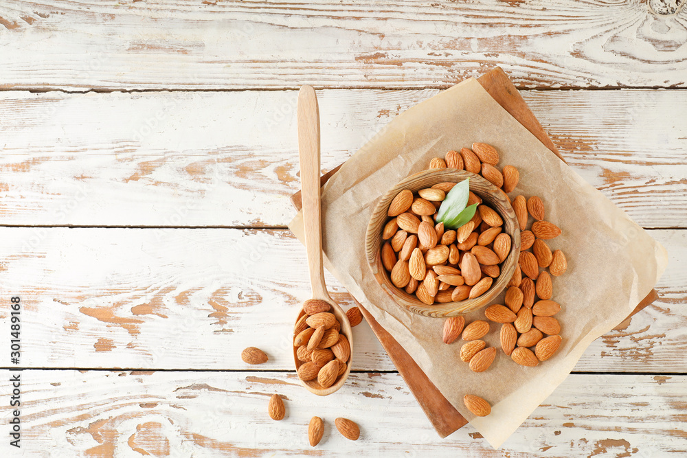 Tasty almonds on wooden table