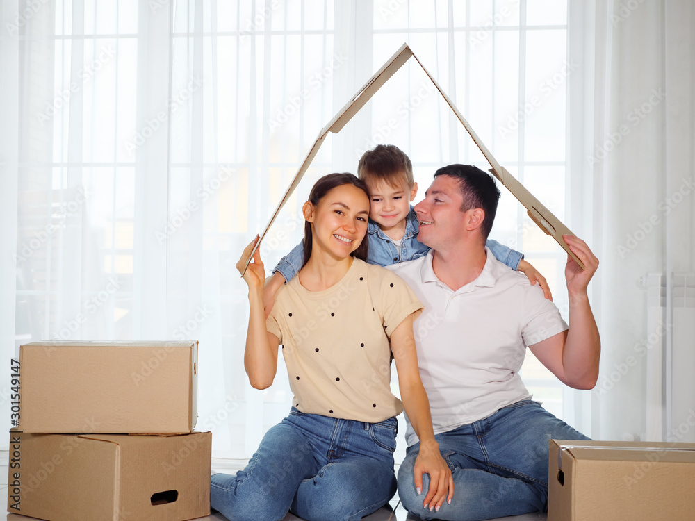 concept housing a young family. Mother father and child in new house with a roof at a home