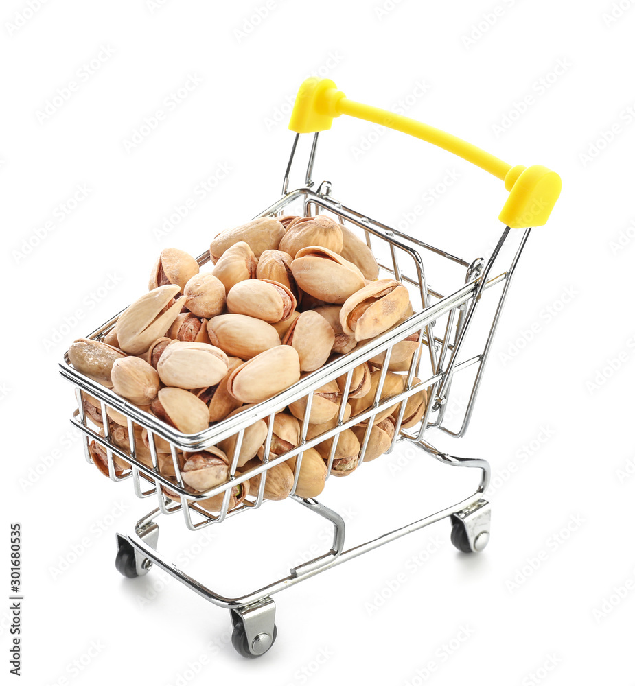 Shopping cart with tasty pistachio nuts isolated on white