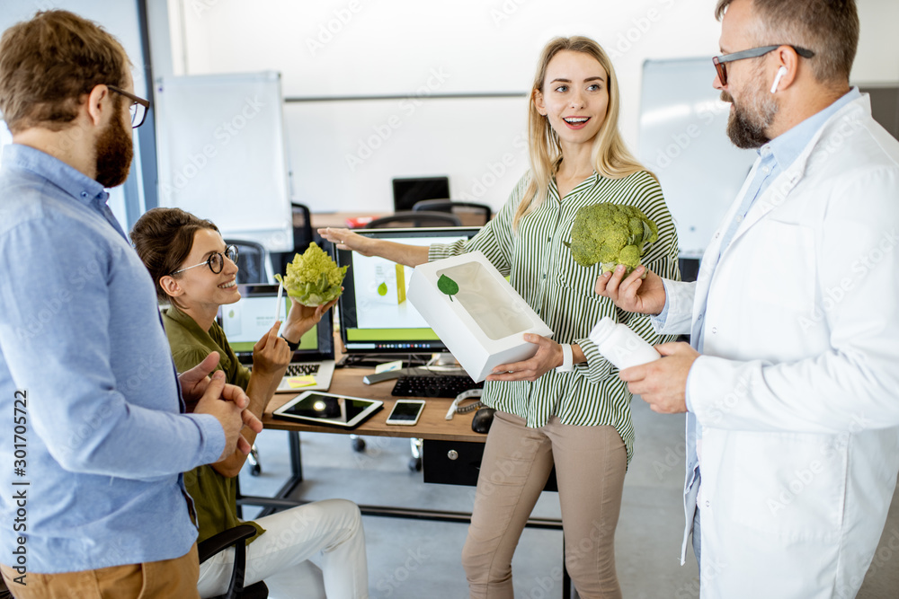 Group of diverse people working on the packaging design of a new eco product in the office. Branding