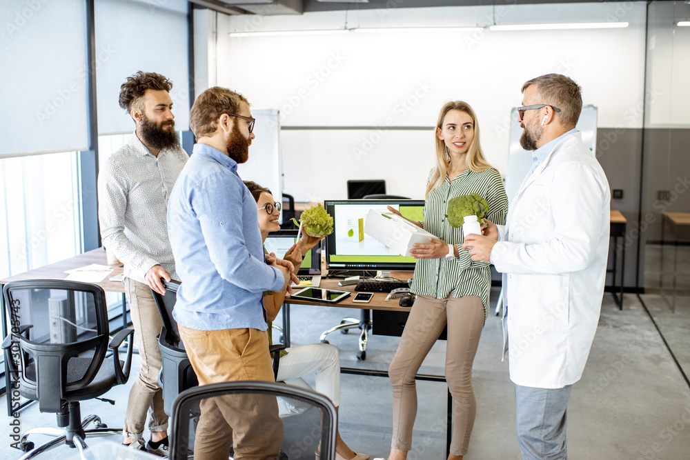 Group of diverse people working on the packaging design of a new eco product in the office. Branding