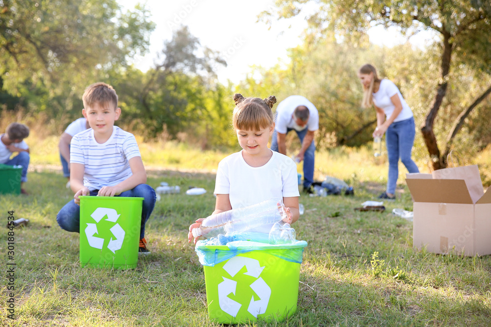 People gathering garbage outdoors. Concept of recycling