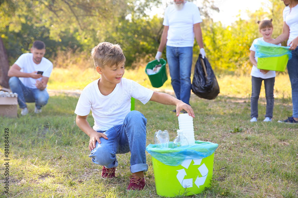 People gathering garbage outdoors. Concept of recycling