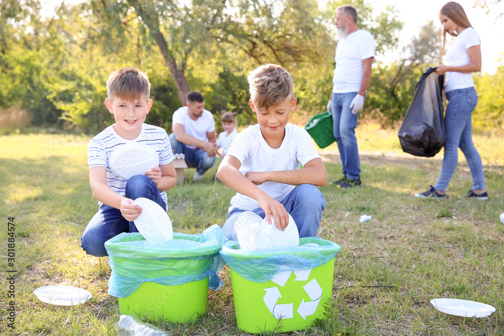 People gathering garbage outdoors. Concept of recycling