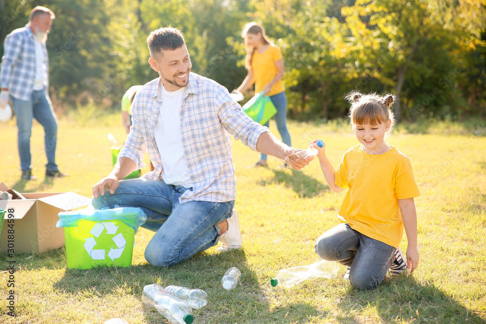 People gathering garbage outdoors. Concept of recycling