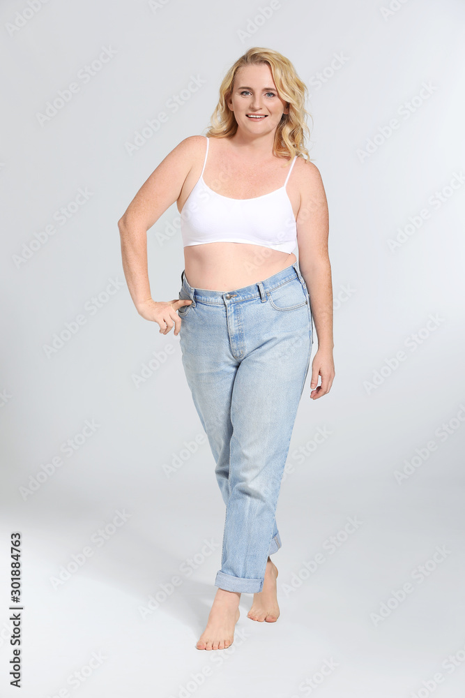 Mature body positive woman on grey background