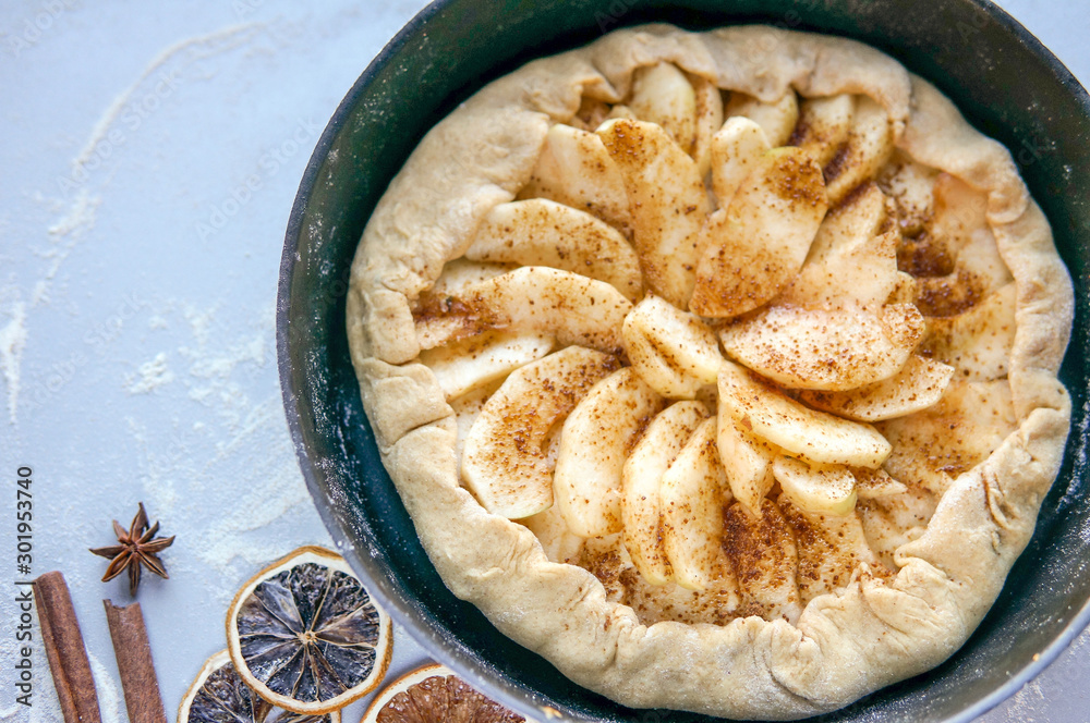 Homemade apple tart on kitchen table. Apple galette with cinnamon