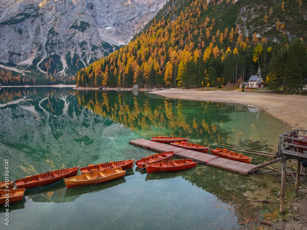 Boats on the Lago di Braies lake in Dolomites at sunrise, Italy