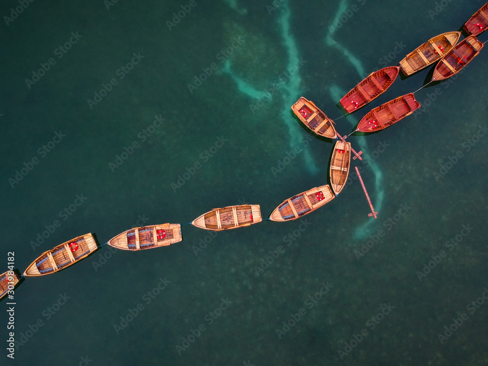 Boats on the Lago di Braies lake in Dolomites at sunrise, Italy