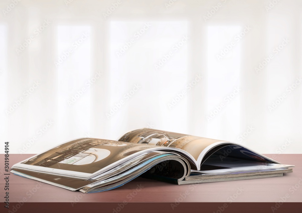 Stack of magazines on white background