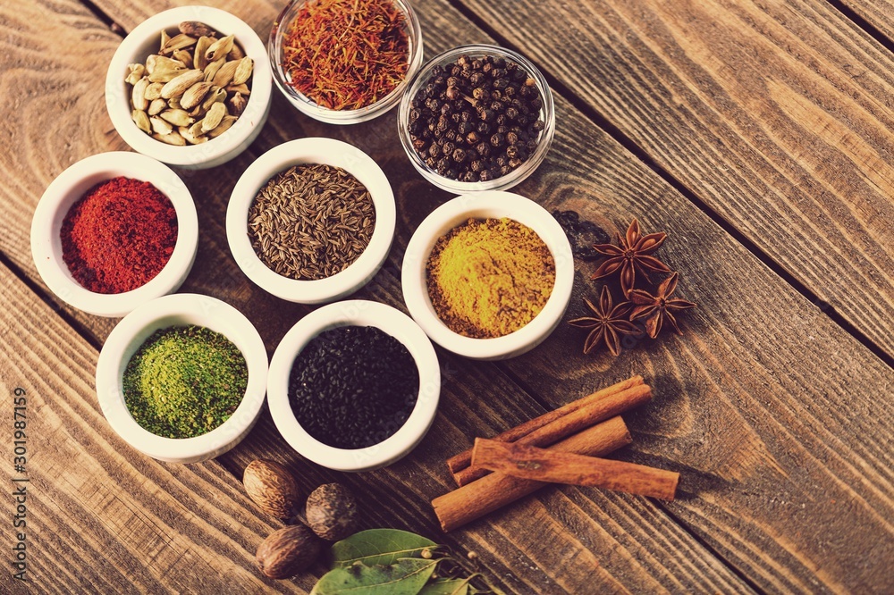 Various colorful spices on wooden table