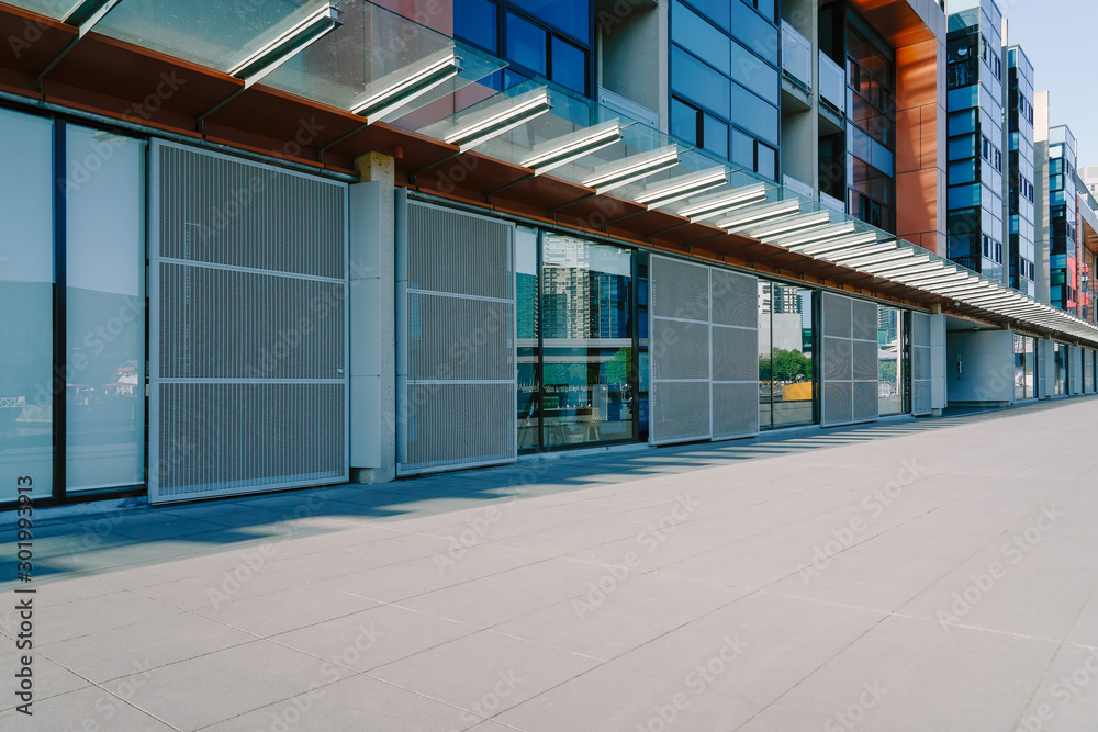 Empty brick road with office building