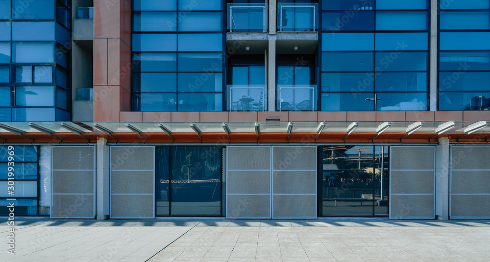 Empty brick road with office building