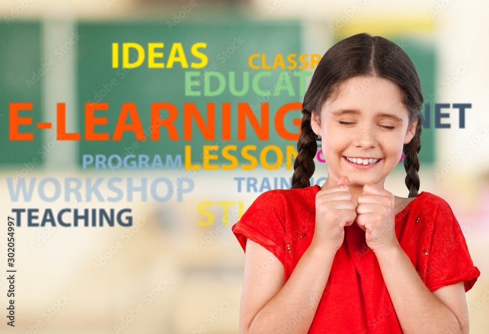 Little student girl with book at classroom