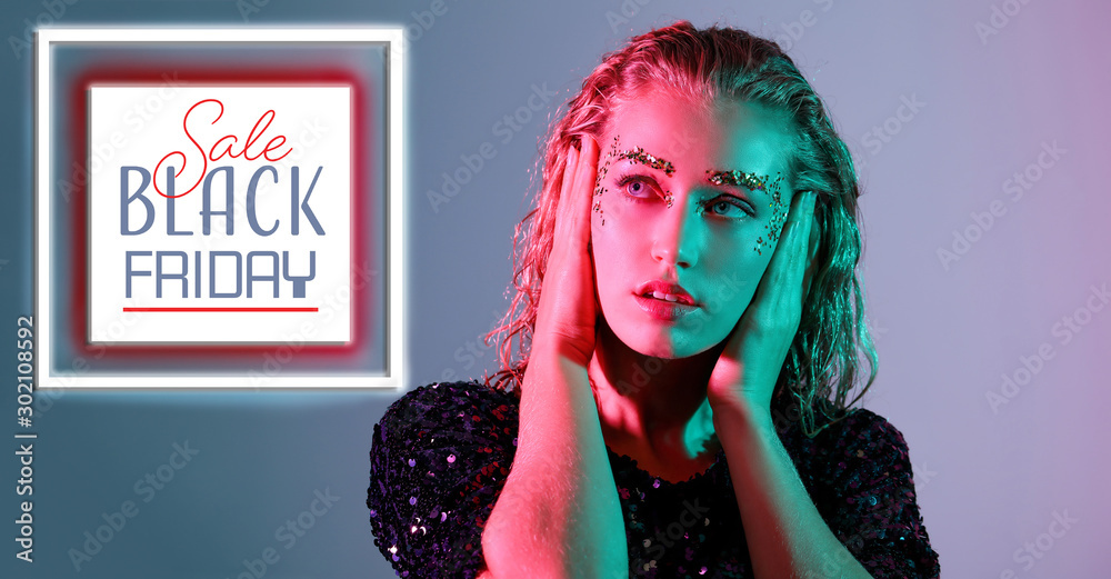 Stylish young woman on color background. Black Friday sale