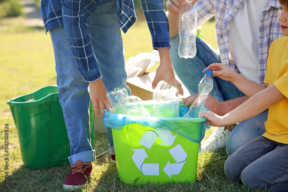 People gathering garbage outdoors. Concept of recycling