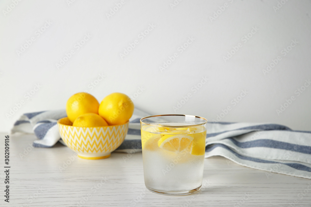 Glass of fresh lemonade on table