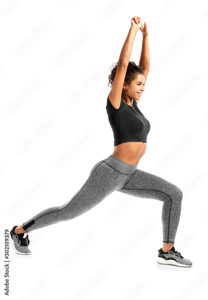 Sporty African-American woman training against white background