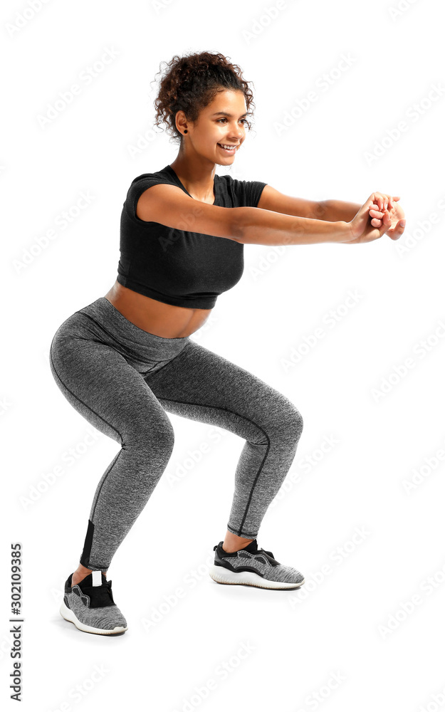 Sporty African-American woman training against white background