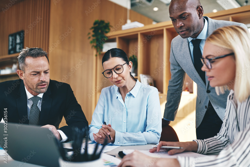 Diverse businesspeople going over paperwork together during an o