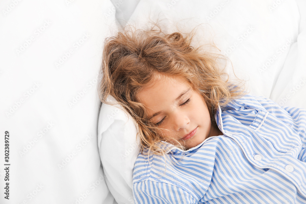 Cute little girl sleeping in bed