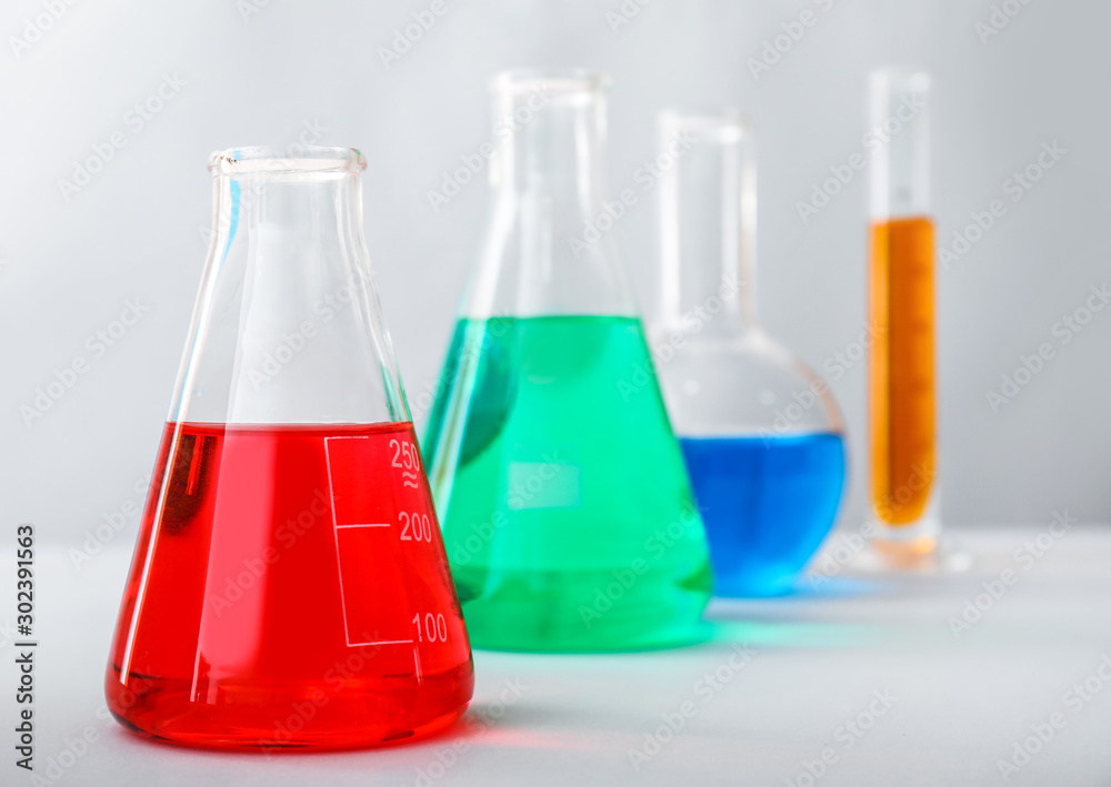 Flasks with colorful samples in laboratory