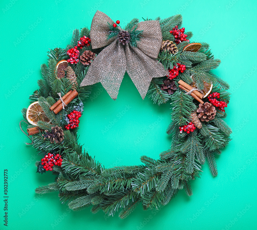 Beautiful Christmas wreath on color background