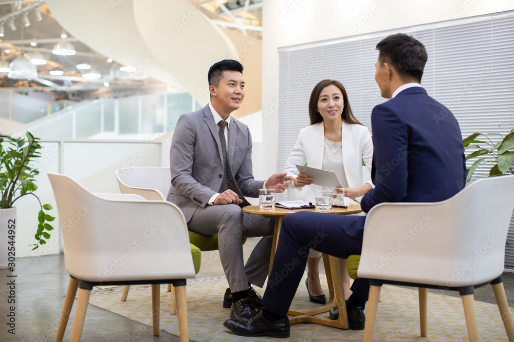 Chinese business people talking in office