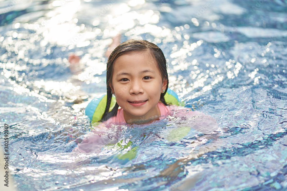 Asian little girl have fun in swimming pool