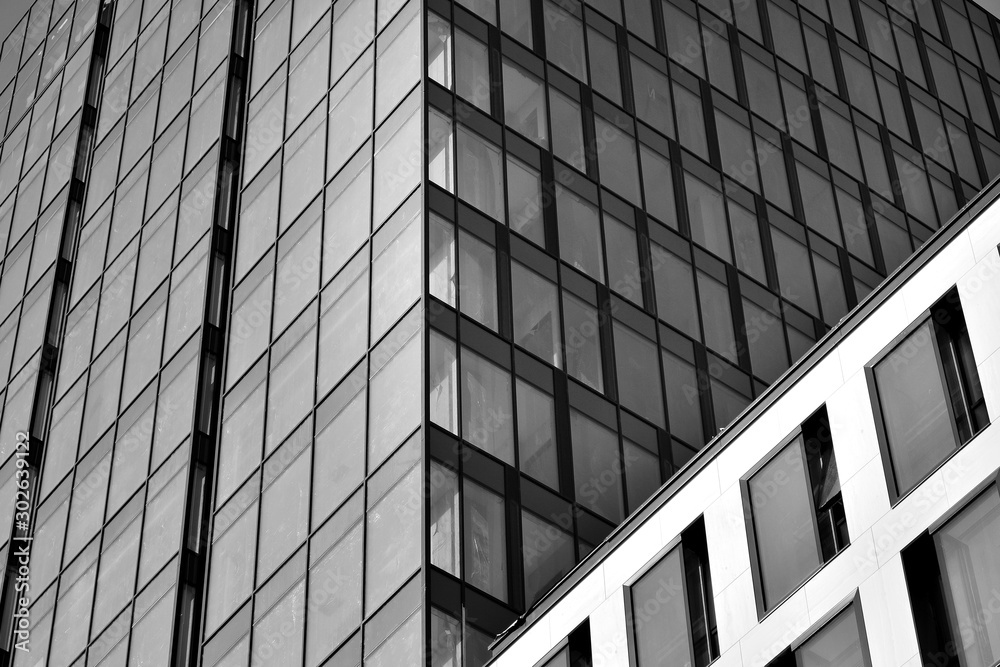 Curtain wall made of toned glass and steel constructions under sky. A fragment of a building. Black 