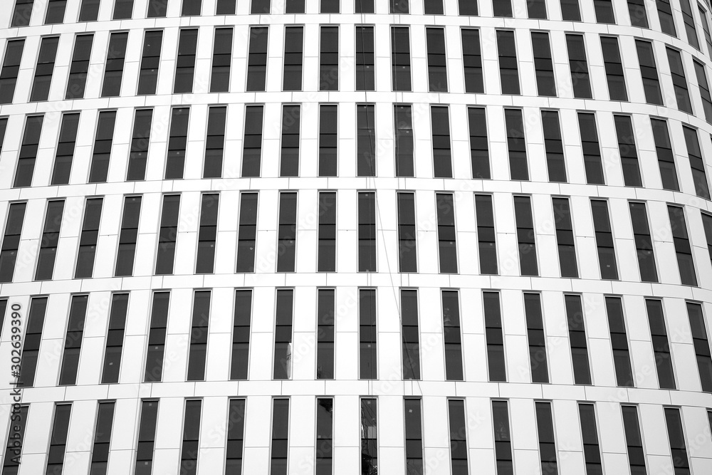 Curtain wall made of toned glass and steel constructions under sky. A fragment of a building. Black 