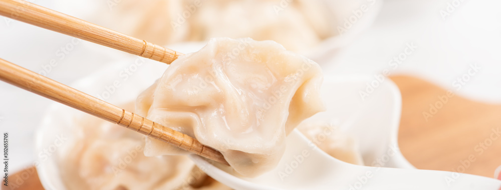 Fresh, delicious boiled pork, shrimp gyoza dumplings on white background with soy sauce and chopstic