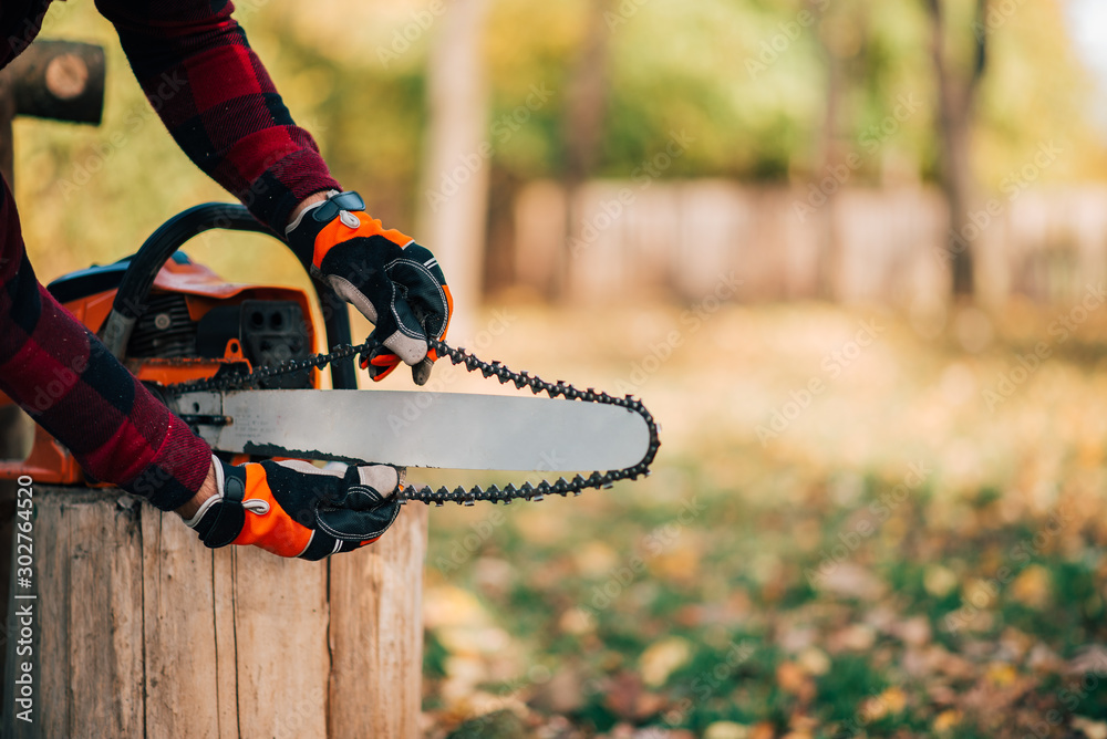 Preparing chainsaw for use, close-up, copy space.