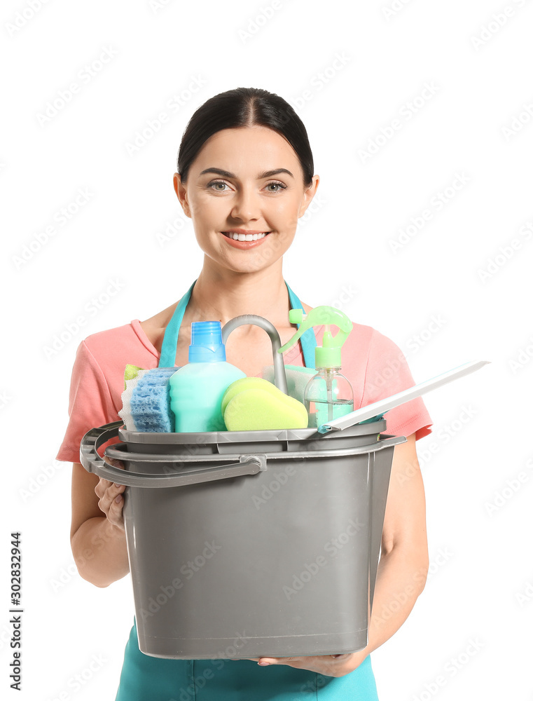 Female janitor with cleaning supplies on white background