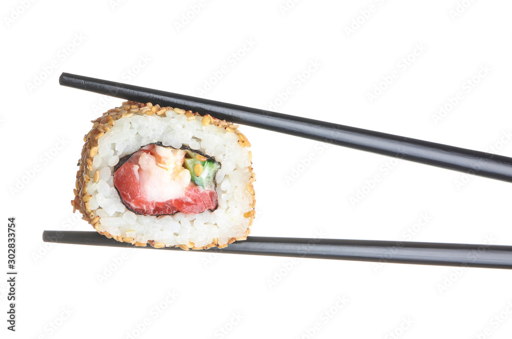 Chopsticks with tasty sushi roll on white background