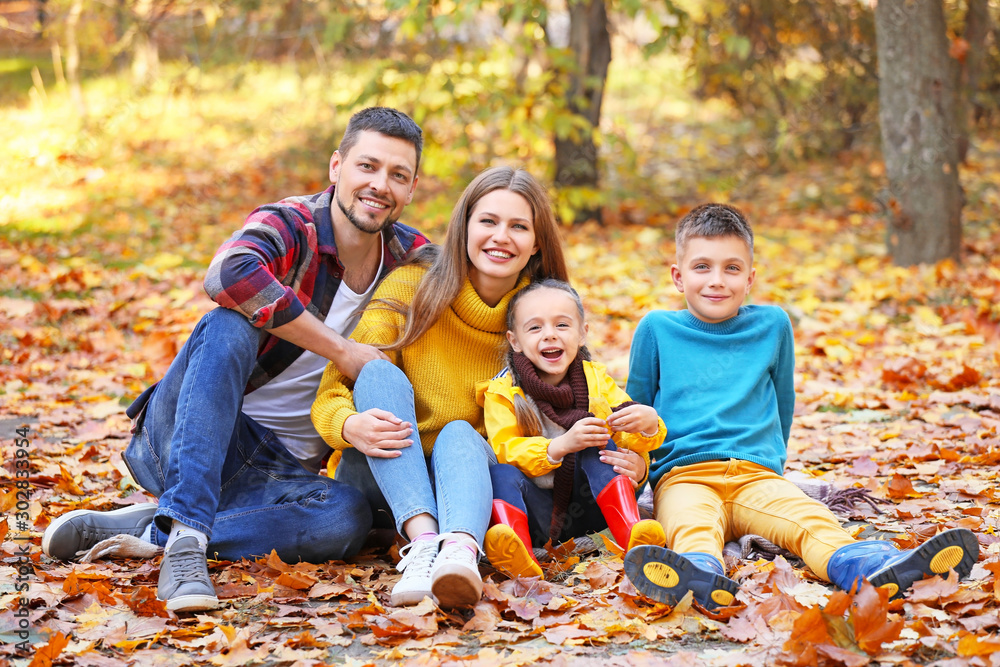 Happy family resting in autumn park