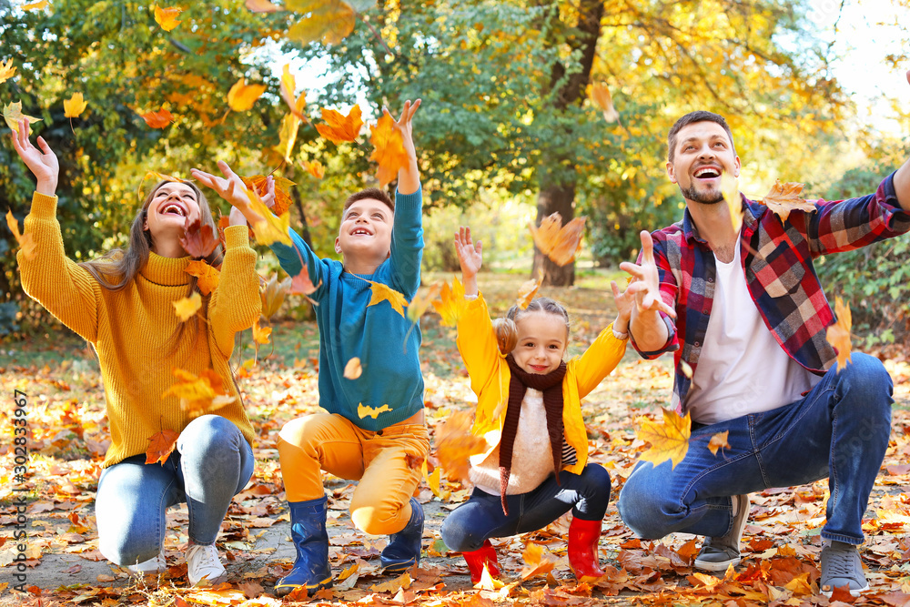 Happy family having fun in autumn park