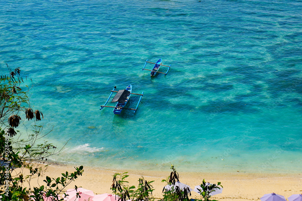  boat on white sand beach in bali -indonesia